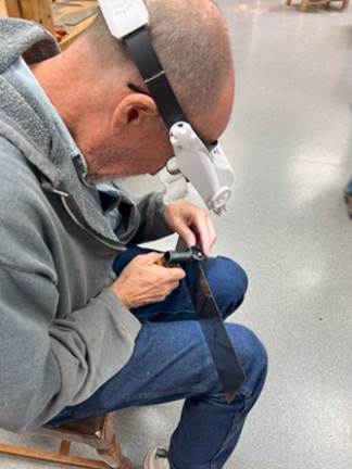 A person wearing a white headband and a grey sweatshirt  Description automatically generated with medium confidence